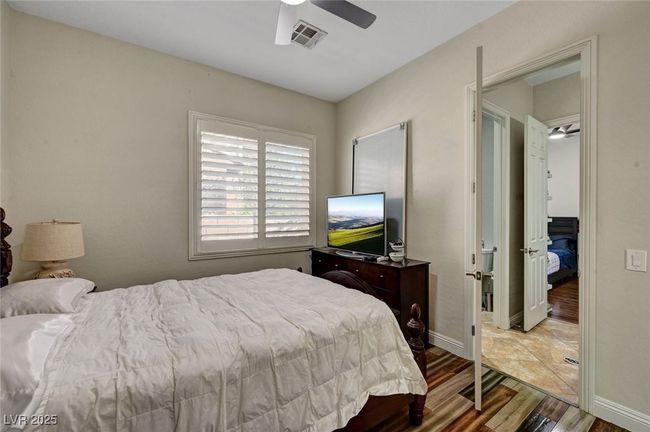 Bedroom featuring wood finished floors and ceiling fan | Image 45