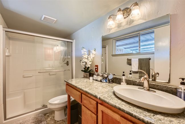 Full bath featuring vanity, a stall shower, and toilet | Image 16