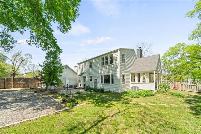 Back of property with a patio, a yard, a fenced backyard, cooling unit, and a chimney | Image 26