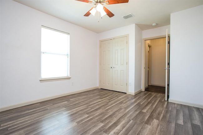 Upstairs bedroom featuring a ceiling fan & LV flooring. The room also shares a Jack & Jill bathroom. | Image 23