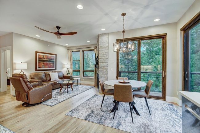 Dining space featuring a healthy amount of sunlight, recessed lighting, light wood finished floors, and ceiling fan with notable chandelier | Image 18