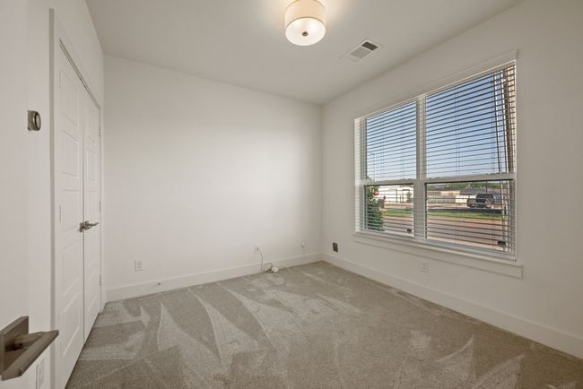 Unfurnished bedroom featuring visible vents, carpet flooring, and baseboards | Image 7