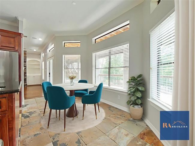 Breakfast area at the end of the kitchen island with tons of natural light and a peaceful view. (virtually staged) | Image 8