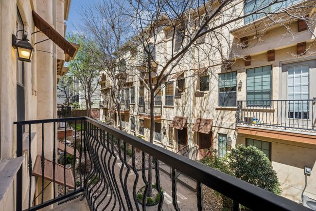 Juliet balcony overlooking a peaceful, tree-lined courtyard. | Image 11