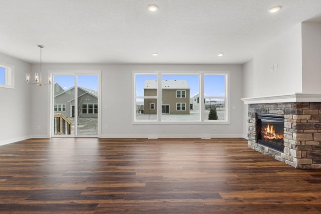 Large windows flood the space with abundant natural light, creating a bright and airy atmosphere in the great room that enhances the home's inviting feel. The generous sunlight highlights every corner, making the room feel open and expansive. | Image 7