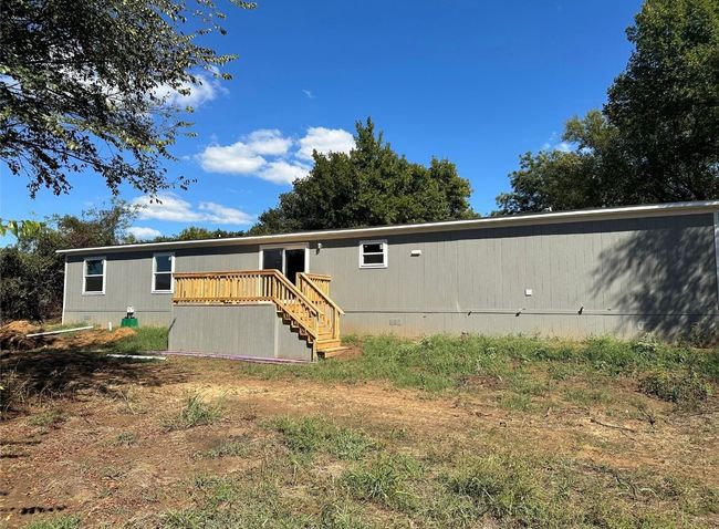 View of back of home featuring crawl space, a deck, and stairs | Image 5