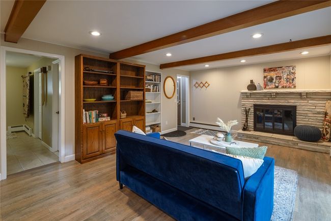 family room with wood burning fireplace, built ins and wood beam ceiling Slider to the flagstone patio | Image 12