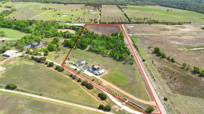 Aerial view of sparsely populated area featuring property parcel outlined and extensive farmland | Image 39
