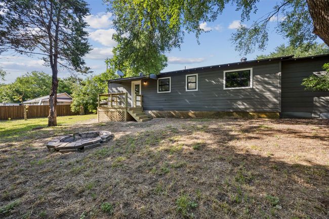 Back of house with a fire pit and a wooden deck | Image 22