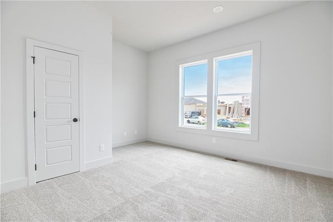 Unfurnished room featuring plenty of natural light and light carpet | Image 31