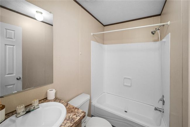 Full bathroom with vanity, washtub / shower combination, toilet, and ornamental molding | Image 12