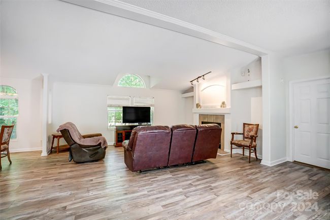 Spacious living area perfect for intimate gatherings with friends and family. | Image 6