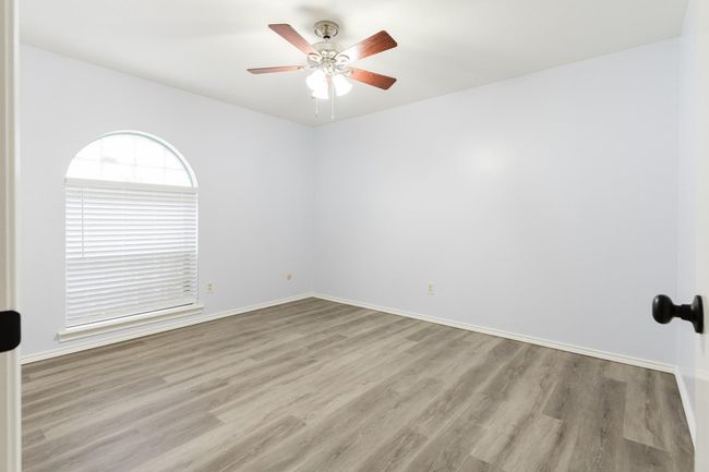 Unfurnished room featuring a ceiling fan, baseboards, and wood finished floors | Image 14