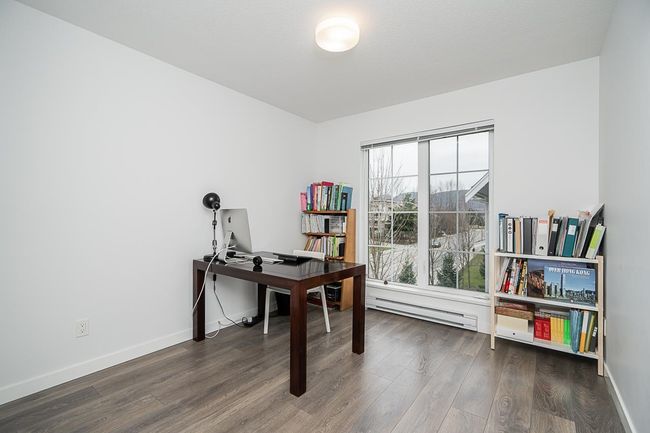 Home office with a baseboard radiator, wood finished floors, and baseboards | Image 22