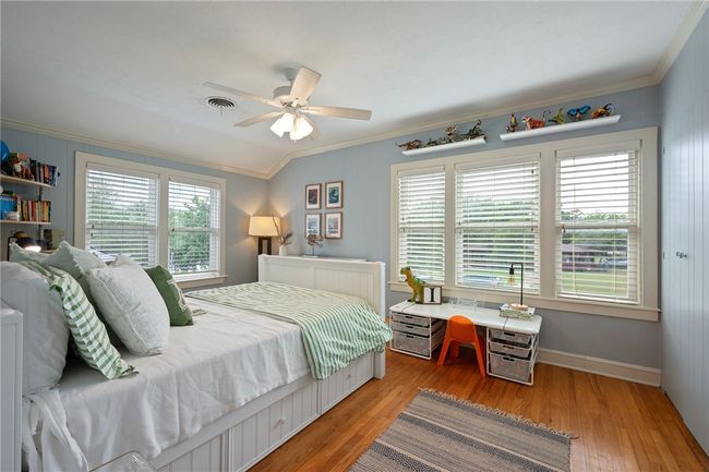 Bedroom featuring ornamental molding, light wood-type flooring, and a ceiling fan | Image 28