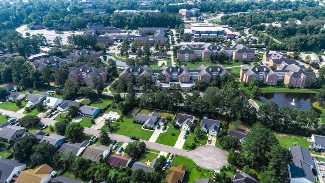 Aerial view of property and surrounding area featuring nearby suburban area and a nearby body of water | Image 14