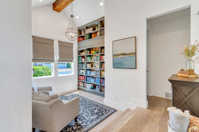 Living area with wood finished floors, recessed lighting, and a chandelier | Image 13