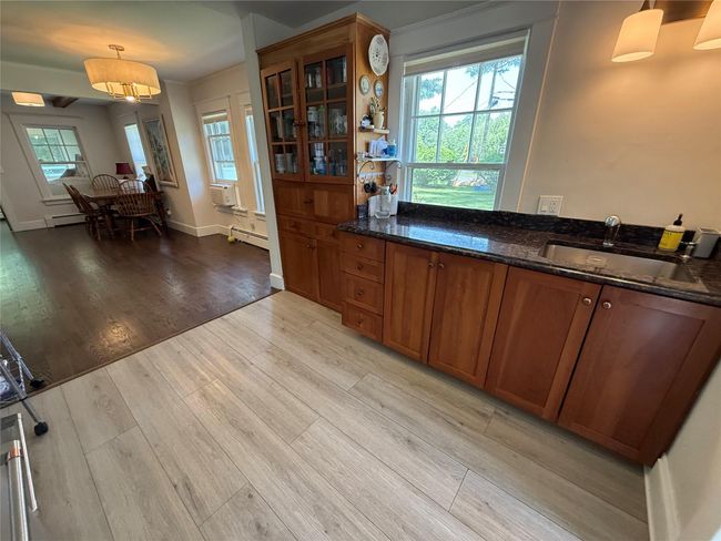 spacious Kitchen with wooden cabinets create a timeless look. | Image 7