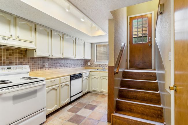 Kitchen has stairs leading to upstairs bedrooms | Image 7