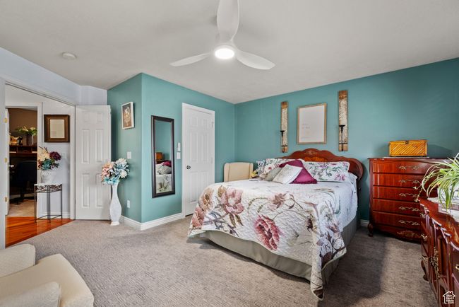 Bedroom with baseboards, a ceiling fan, a closet, and carpet | Image 12