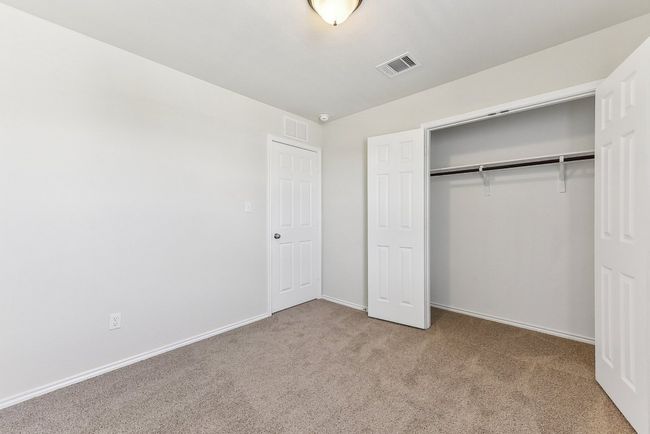 Unfurnished bedroom with visible vents, a closet, and carpet flooring | Image 29