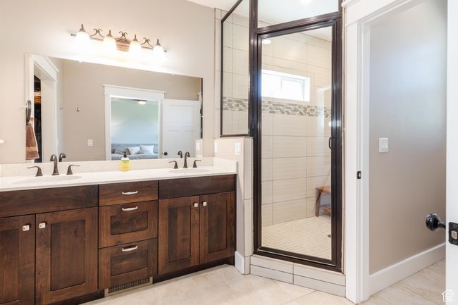Ensuite bathroom with a stall shower, double vanity, and tile patterned floors | Image 23