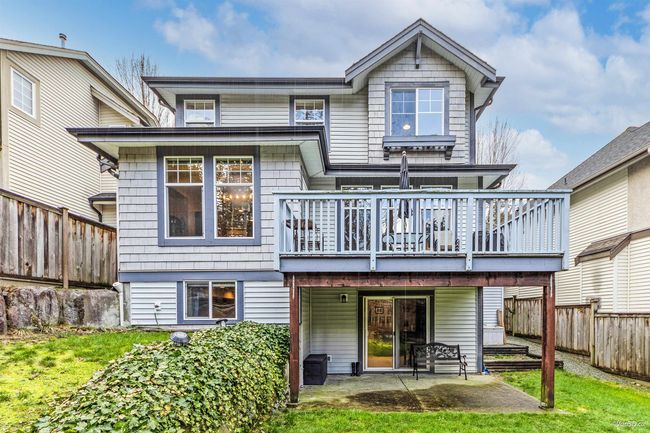 Rear view of house with a patio area, a wooden deck, and a fenced backyard | Image 29