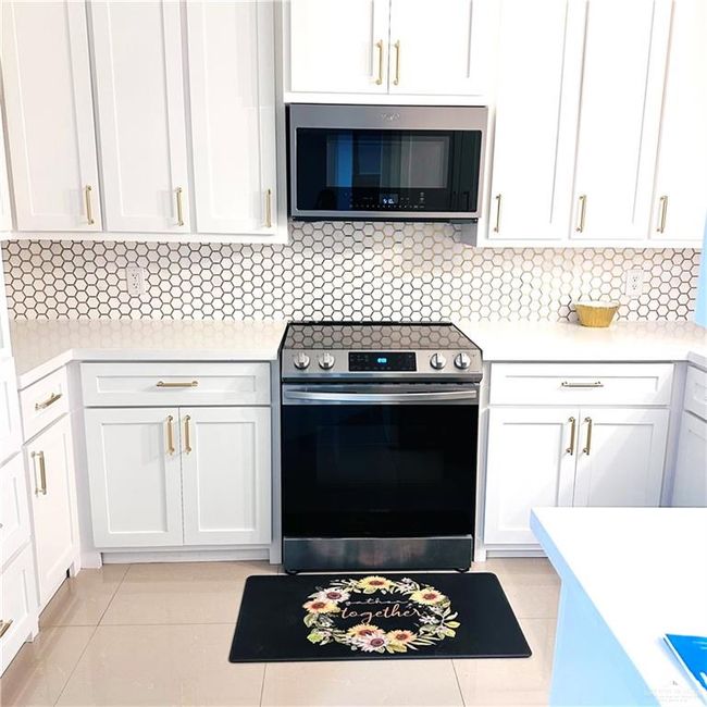Kitchen with appliances with stainless steel finishes, light countertops, white cabinets, and tasteful backsplash | Image 6
