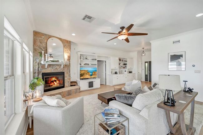 A gorgeous stone fireplace serves as a stunning focal point, adding warmth and elegance to the space | Image 12