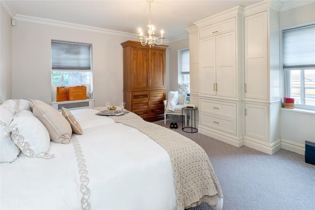 Carpeted bedroom with a chandelier, multiple windows, and crown molding | Image 12