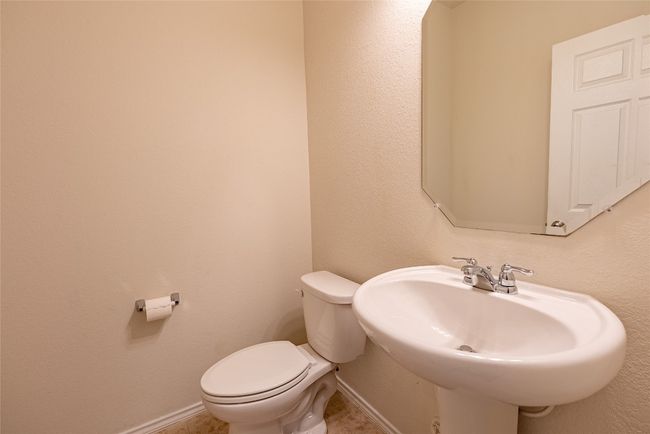 Half bath featuring a textured wall and toilet | Image 9