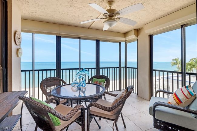 Sunroom / solarium with a water view and ceiling fan | Image 24