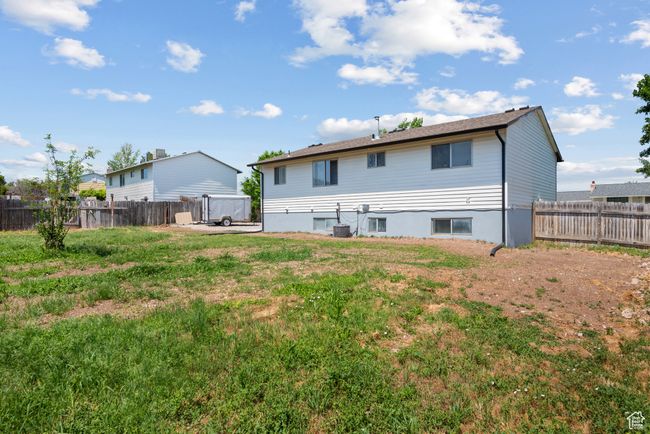 Back of house with a fenced backyard | Image 15
