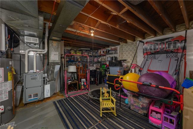 Unfinished basement featuring water heater and heating unit | Image 19