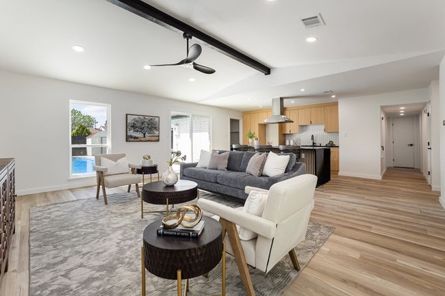 Living room featuring ceiling fan, light wood-type flooring, visible vents, recessed lighting, and vaulted ceiling with beams | Image 16