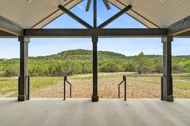 Step outside onto the expansive covered back porch to toast to the epic hill country vistas. | Image 36