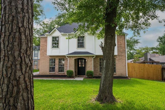A stunning front yard with mature trees that provide shade and character | Image 4