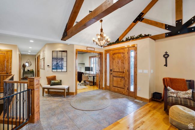 Foyer featuring high vaulted ceiling, a chandelier, wood finished floors, baseboards, and beamed ceiling | Image 4