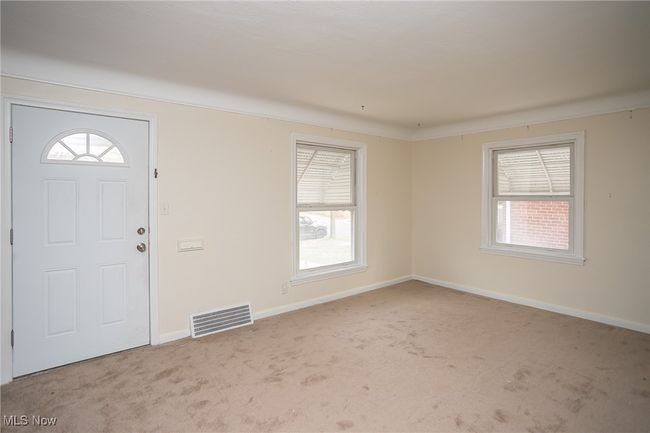 Carpeted foyer entrance featuring baseboards | Image 8