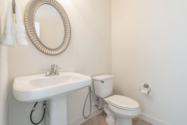 Bathroom featuring baseboards, a sink, and toilet | Image 12