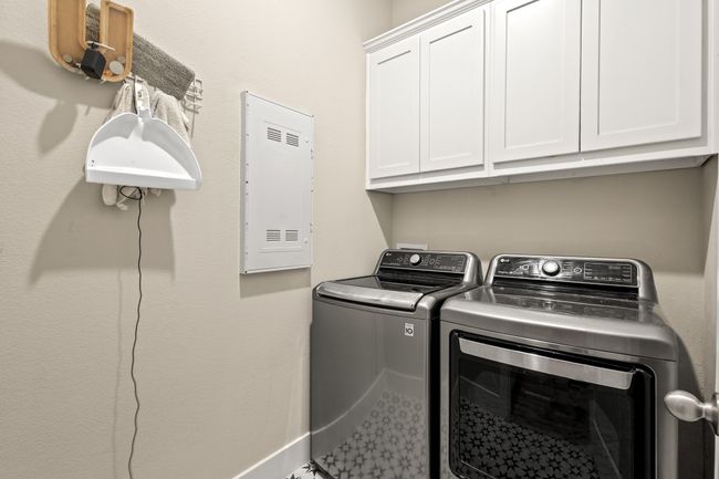 Laundry area featuring cabinet space and separate washer and dryer | Image 17