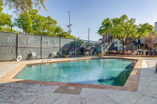 View of swimming pool featuring fence, a patio area, and a fenced in pool | Image 25