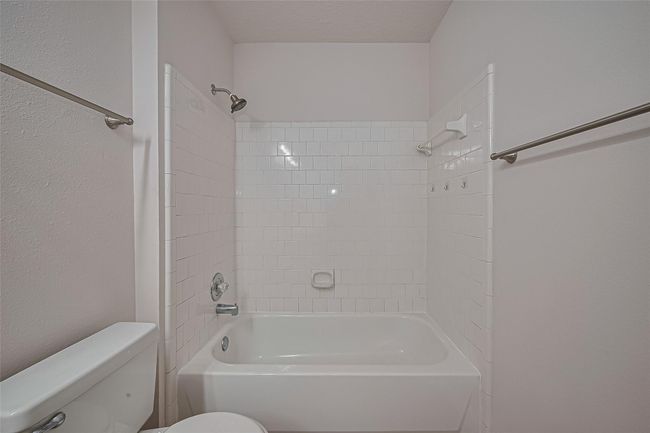 Upstairs bathroom features a tub/shower combo and lighted vanity mirrors for a modern, functional touch. | Image 36