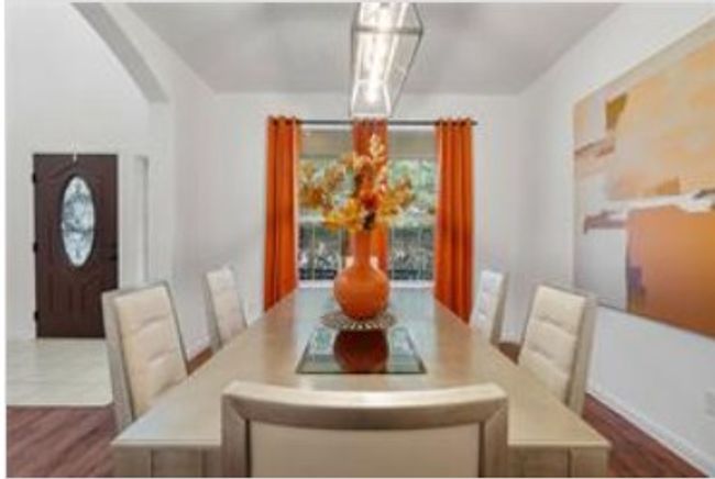 Dining space featuring dark wood-style floors and arched walkways | Image 10