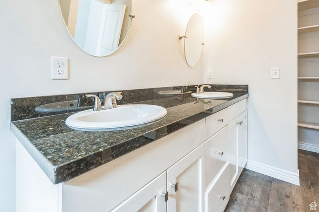 Full bathroom featuring double vanity and wood finished floors | Image 33