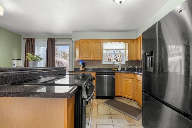 Everything within your reach in this lovely kitchen open to dining and living room area. Family chef can enjoy family and friends while cooking. | Image 9