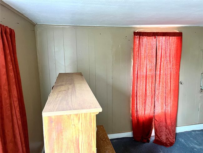 Detailed view of carpet flooring and wood walls | Image 4