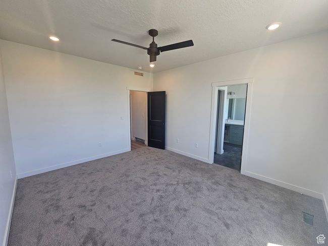 Unfurnished bedroom featuring carpet, baseboards, recessed lighting, ensuite bath, and ceiling fan | Image 16