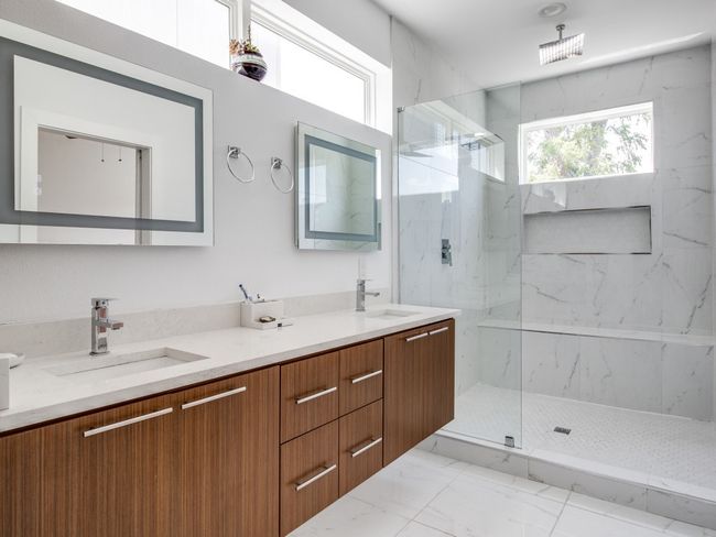 Bathroom featuring marble look tiles, a marble finish shower, and double vanity | Image 21