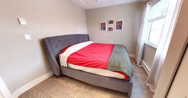Bedroom with a baseboard radiator and baseboards | Image 16